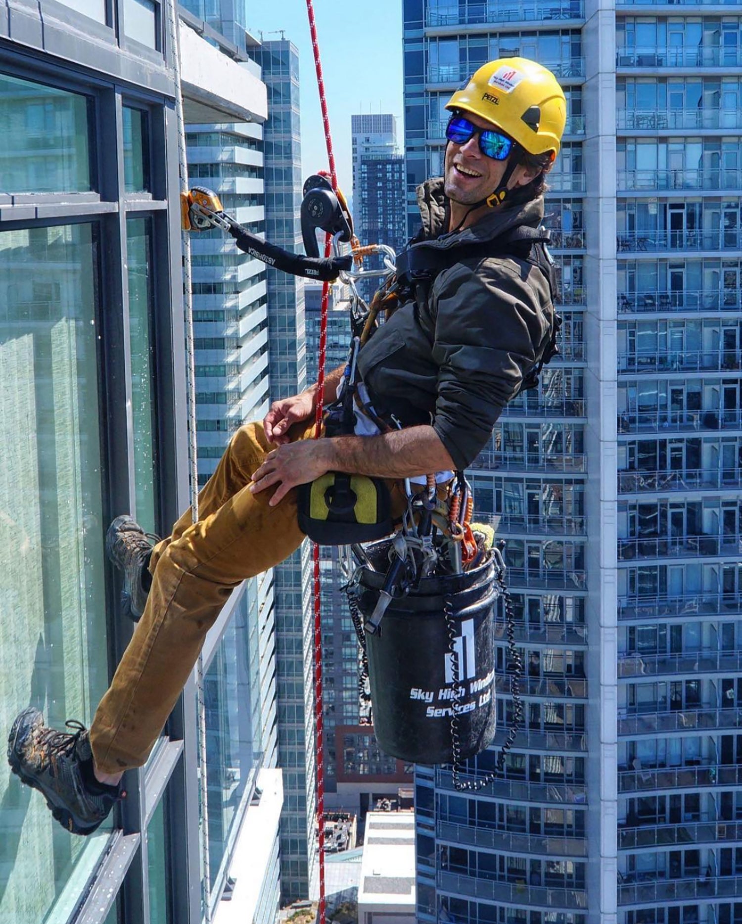 High-rise commercial window cleaner working on building exterior in Toronto